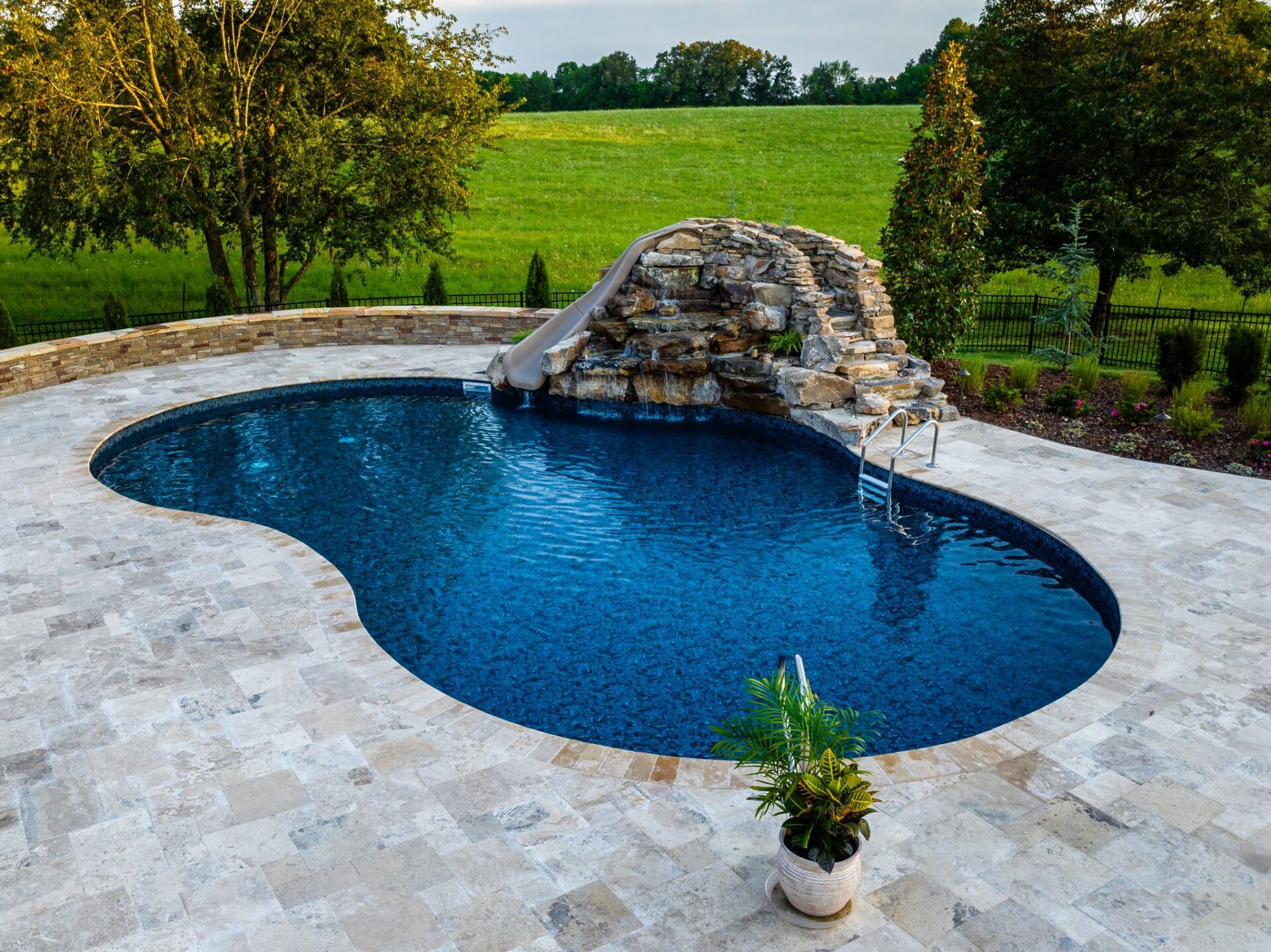 Waterfall feature for a new pool designed by New Beginnings in Nashville, TN
