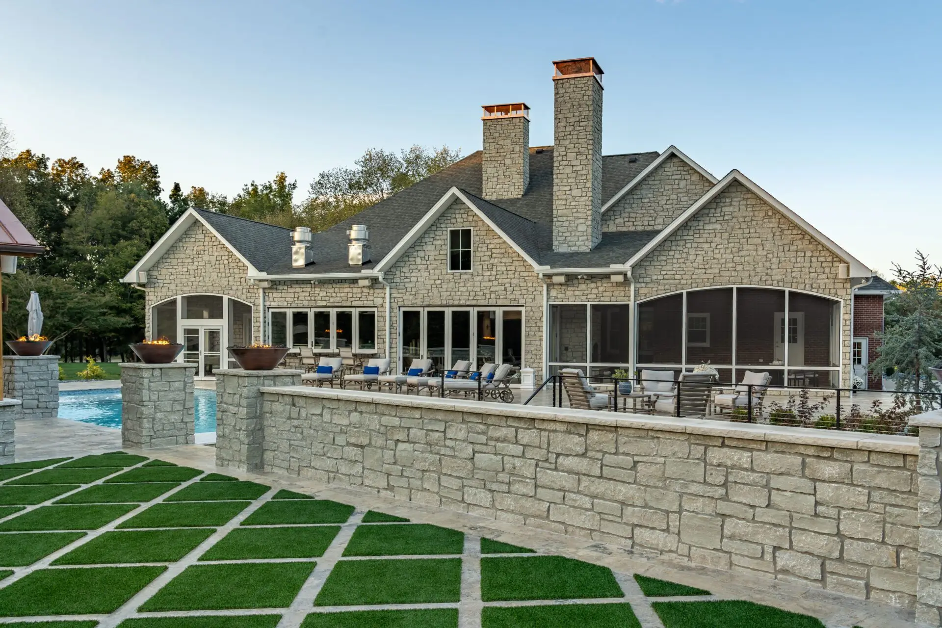 A large home featuring a swimming pool and a spacious patio area.