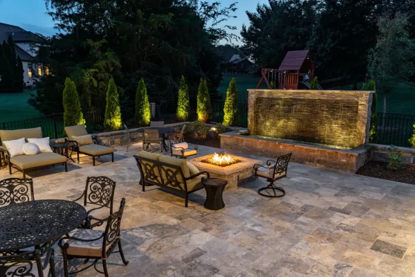 A charming patio with a central fire pit and ample seating, perfect for enjoying evenings outdoors with friends.