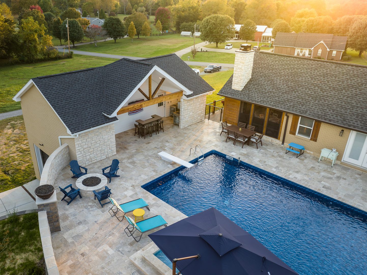 A backyard with a sparkling pool and stylish patio furniture, creating an inviting space for outdoor enjoyment and relaxation.